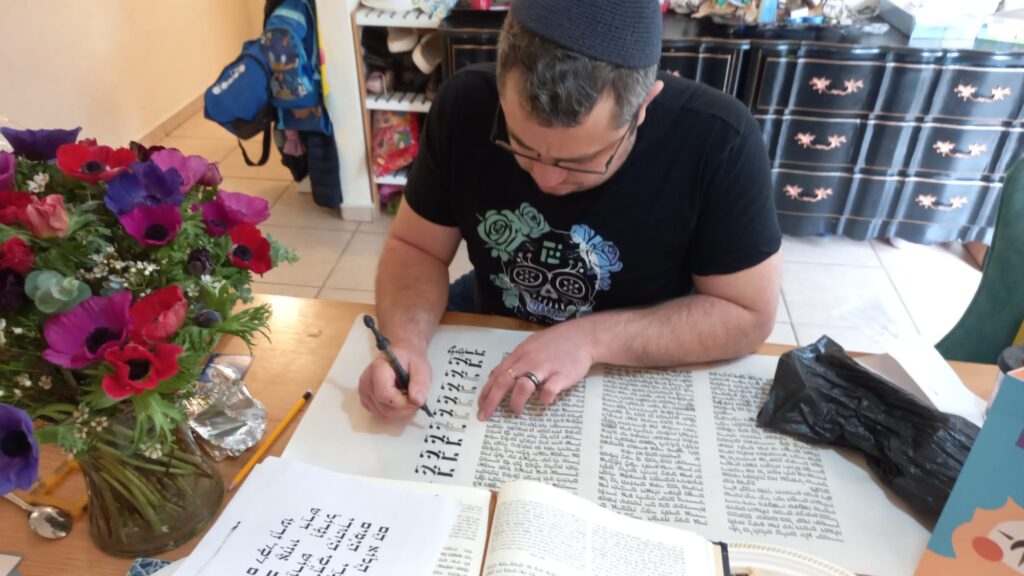 Gedalyah Reback writing a Megillat Esther